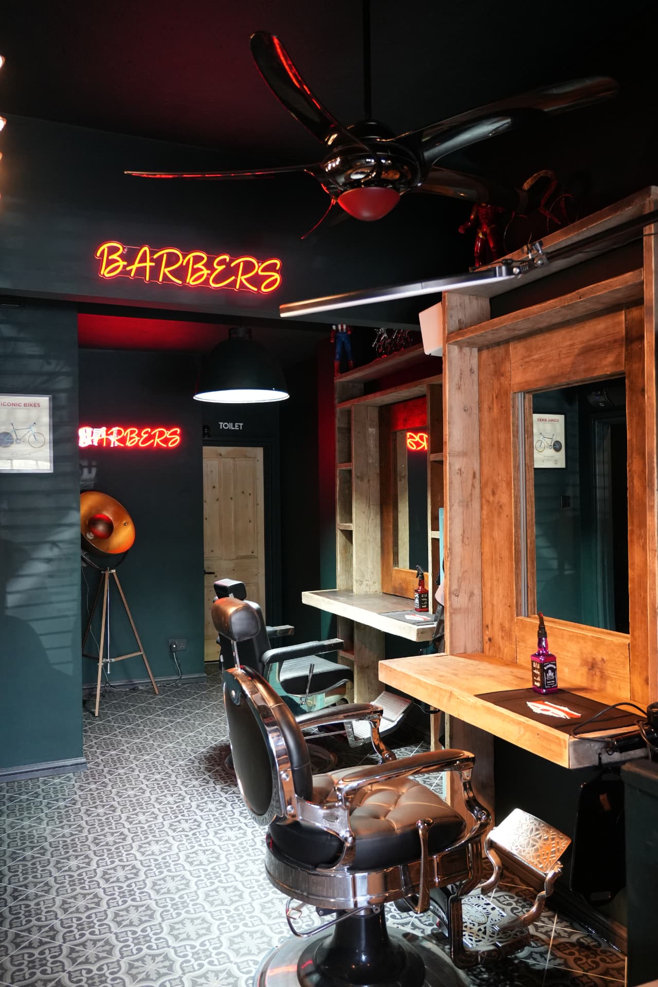Barber chair, timber mirror station and red neon BARBERS sign